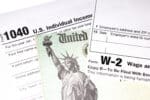 Tax return with Refund Check and W-2 Wage statement on a white background.